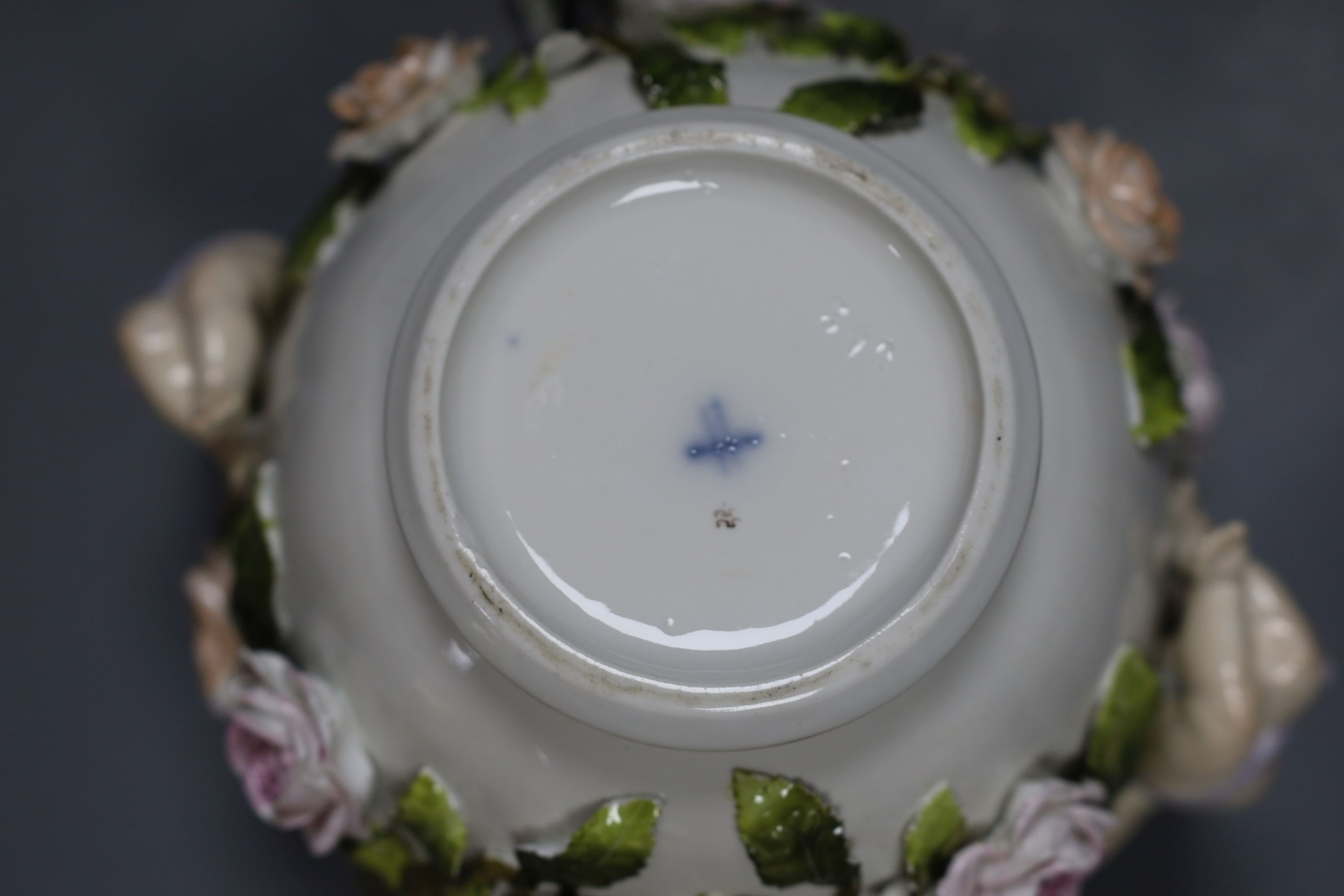 A late 19th century Sitzendorf cherub jardiniere, 18cm tall, and a porcelain floral wall bracket